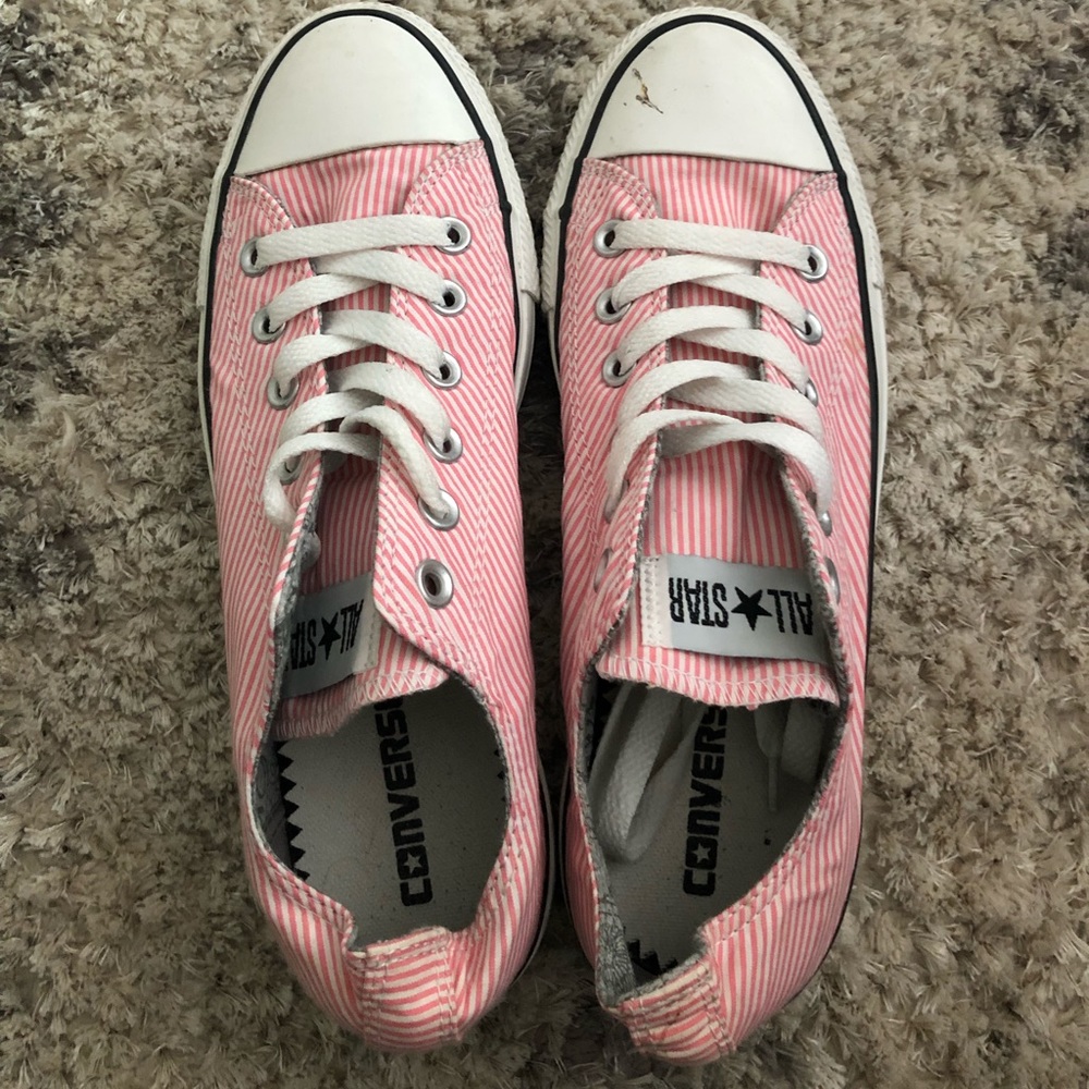 White and pink striped converse sneakers.